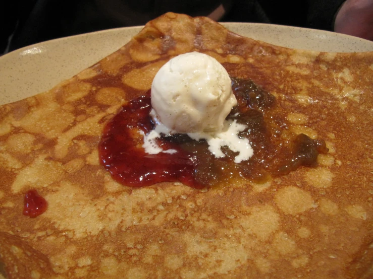 a white plate topped with pancakes and syrup