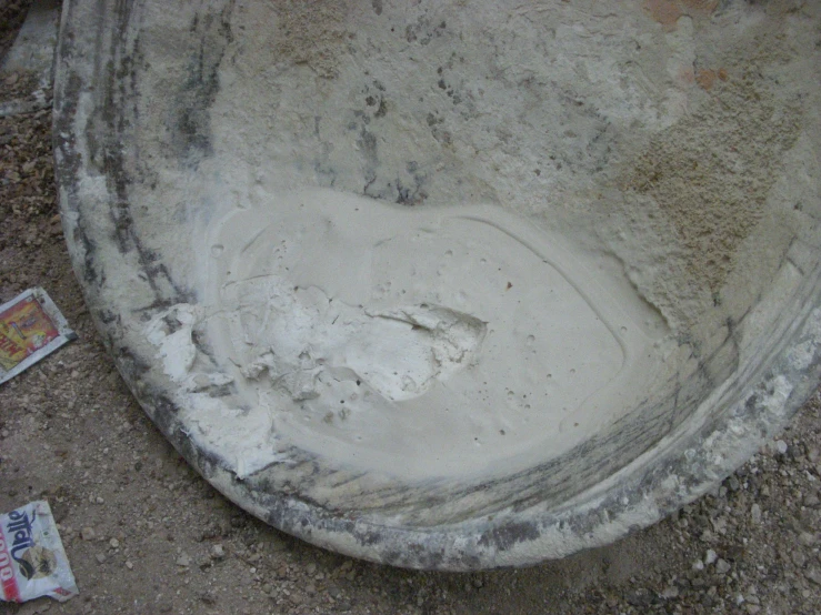 a cement plate with holes in it on the ground