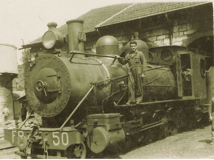 a man is posing on a black and white image next to a train