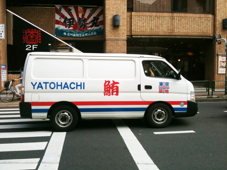 a white van in an oriental country with an asian character on the back