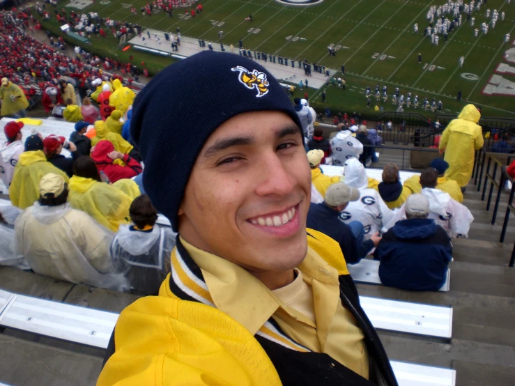 a man wearing a hat at the football game