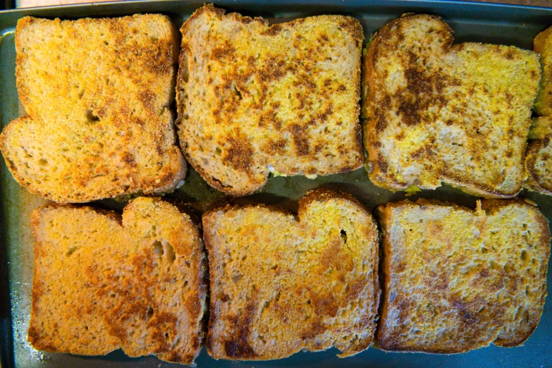 a baking dish with slices of a grilled cheese sandwich