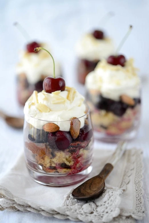 small jars filled with layered desserts on top of a table