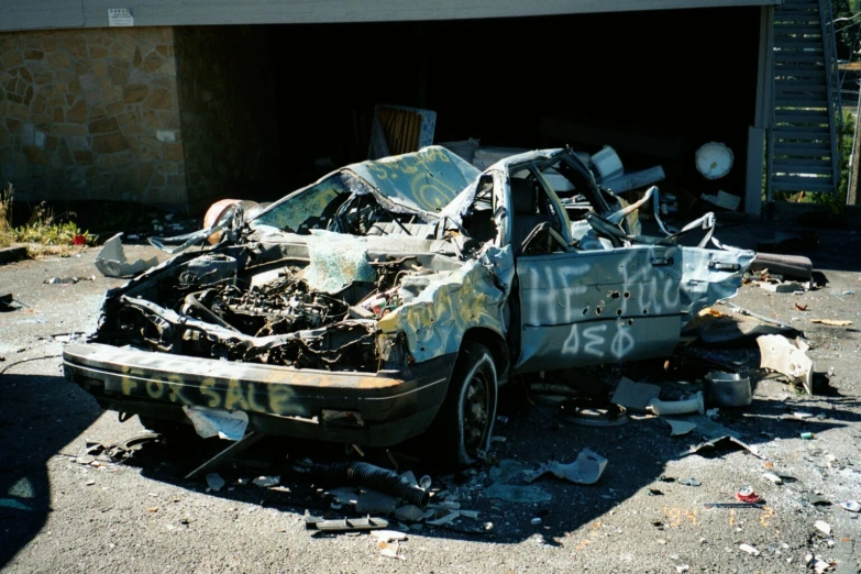 a wrecked car is sitting on the ground