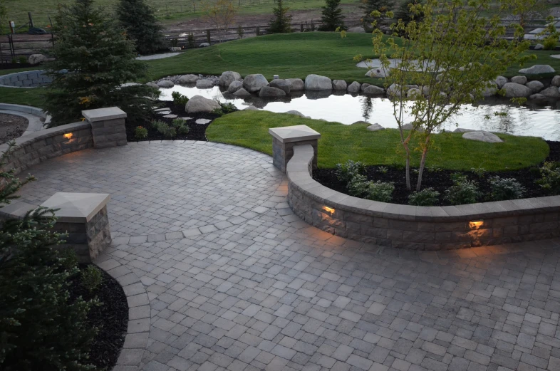 an outside view of a stone paved patio with lighting