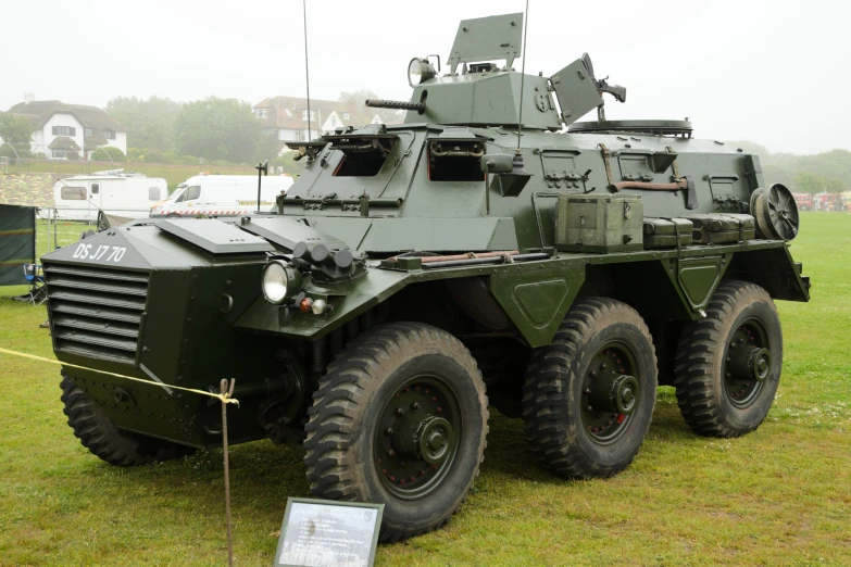 a green armored vehicle in a grass field