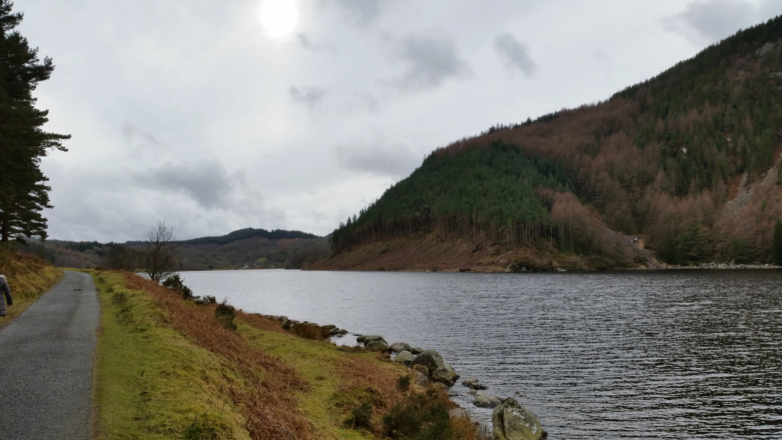 the person is riding his bike beside a lake