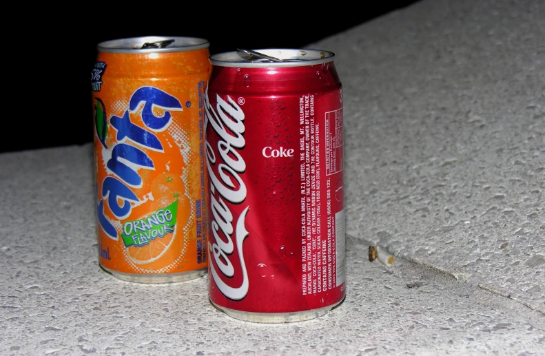 two cans of soda on the table