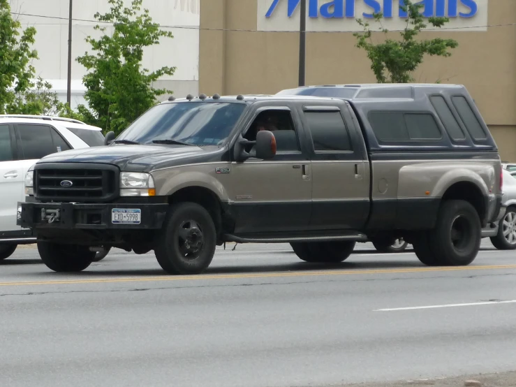 a truck is traveling down the road while parked