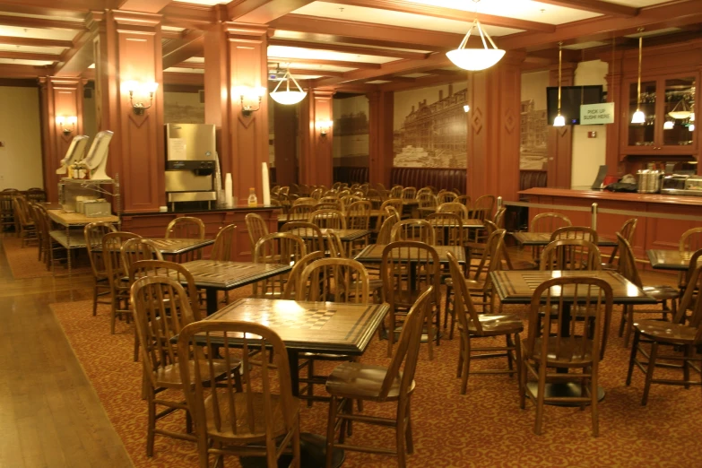 an empty room with multiple tables and chairs in it