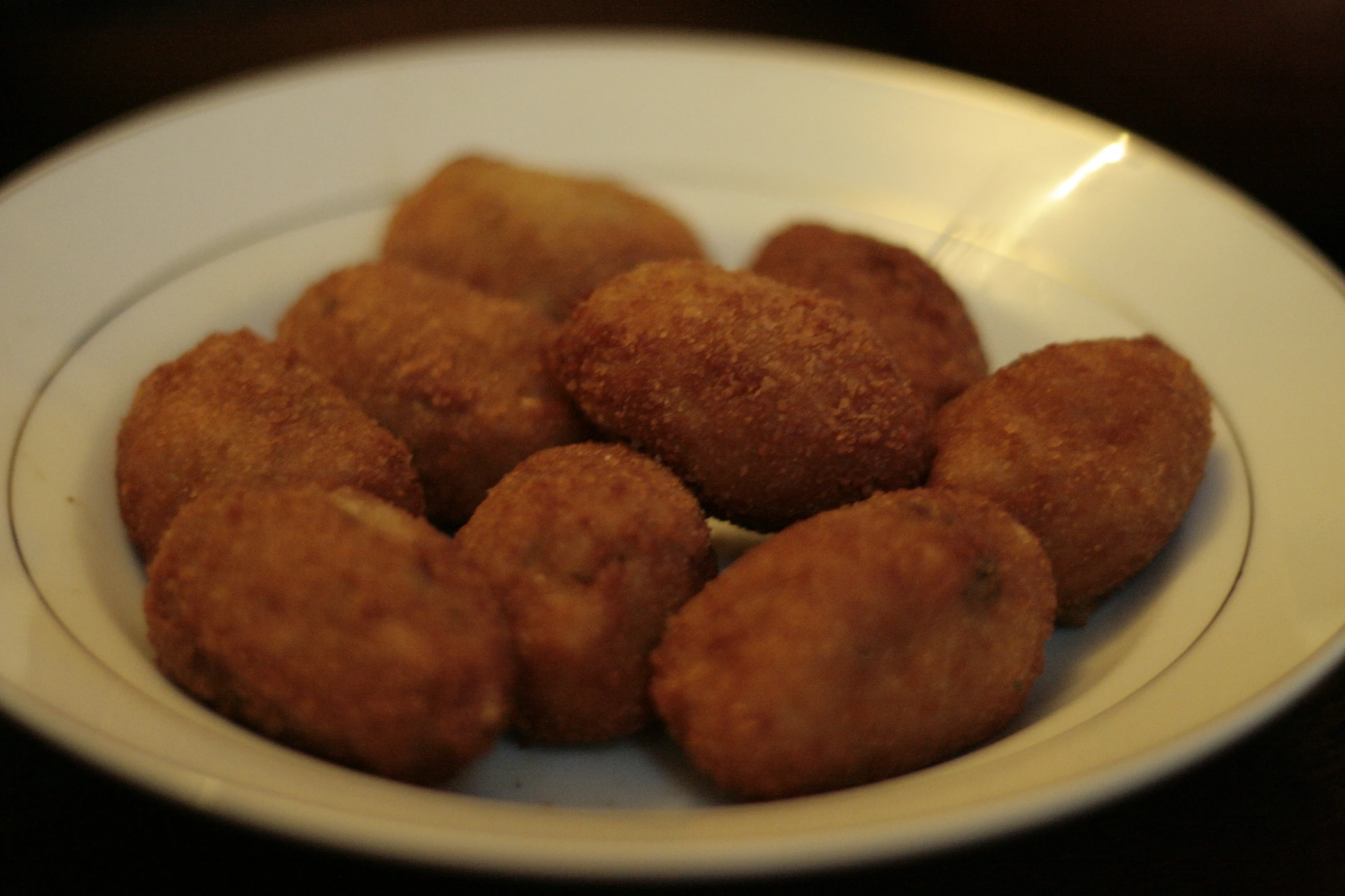 white plate filled with fried pastries on a table