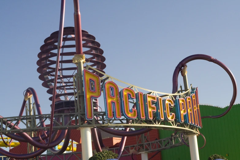 the roller coaster sign in front of a building