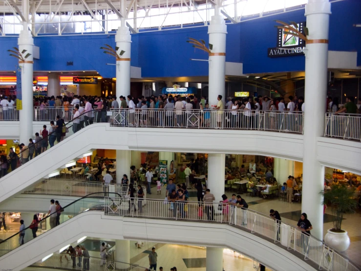 a busy shopping mall filled with people walking through it