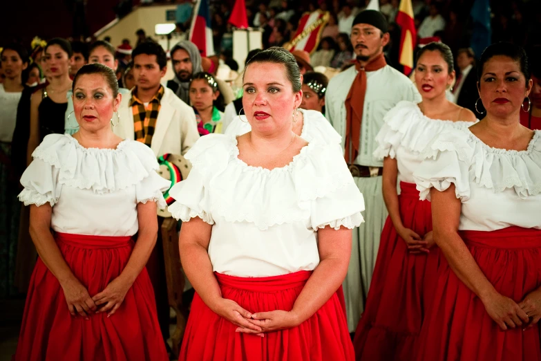 two women and several men standing in front of people