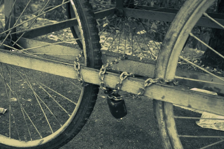 a chain encribed bicycle wheel sits on a walkway