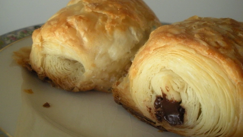 chocolate stuffed croissant on a floral - themed plate