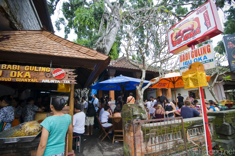 people are eating outside of a restaurant in the wilderness