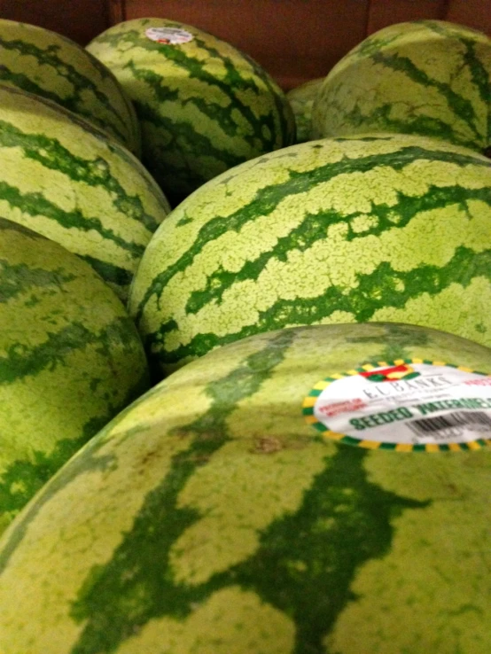 the large group of large watermelons are piled up