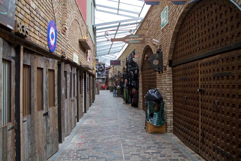 an alley in a brick and glass covered building