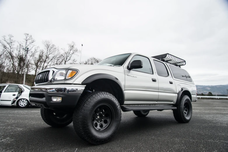 a grey pick up truck with big tires