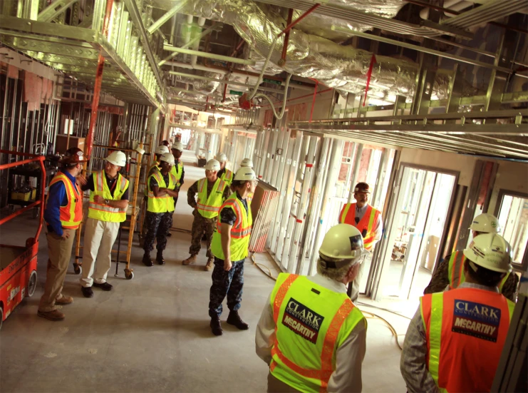 men in safety vests and hard hats talking to each other