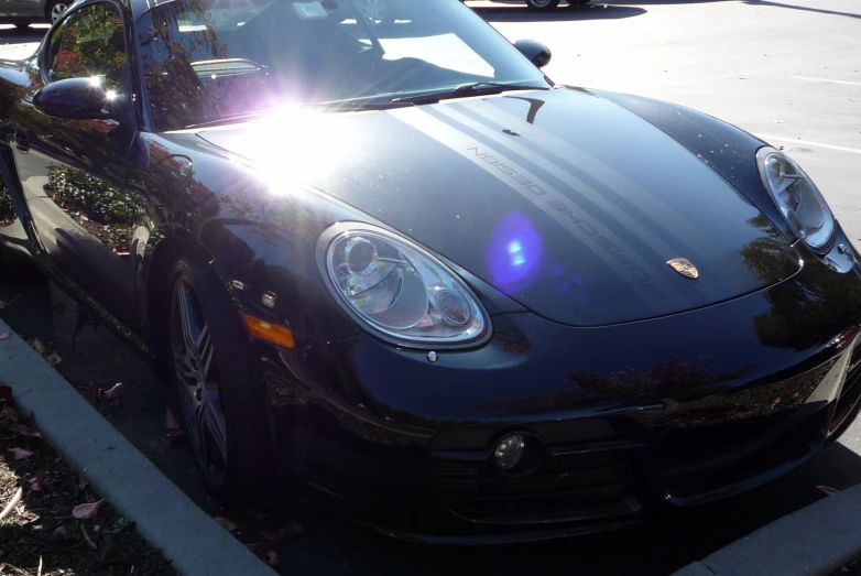 a black sports car sits parked in a lot