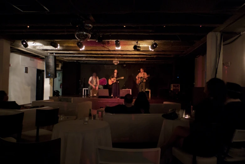 musicians on stage at restaurant during evening