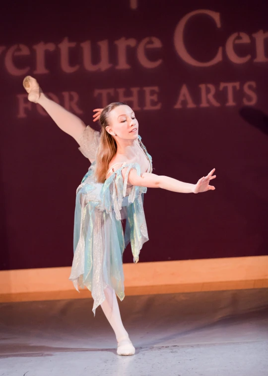 a  wearing a blue dress dancing