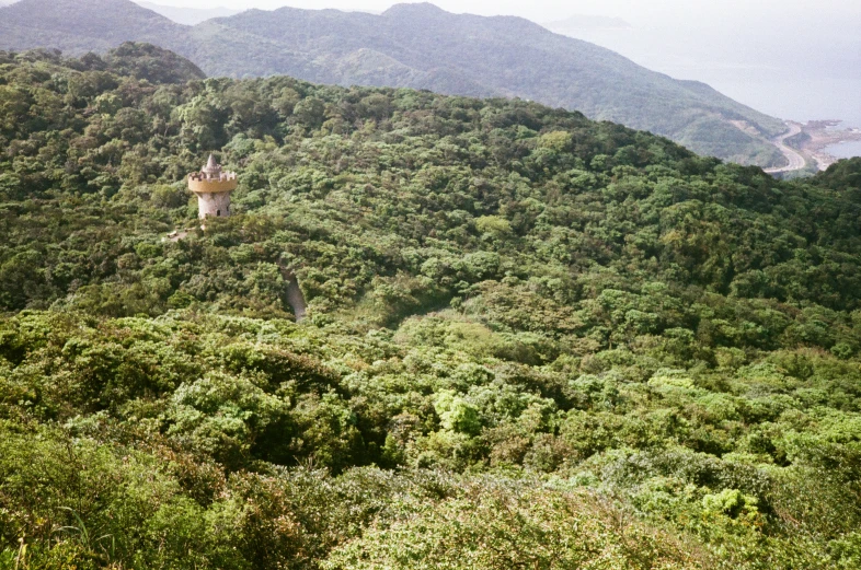 the mountains are covered in green vegetation