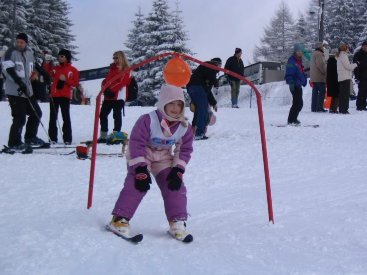 a small child on skis in a snowy park