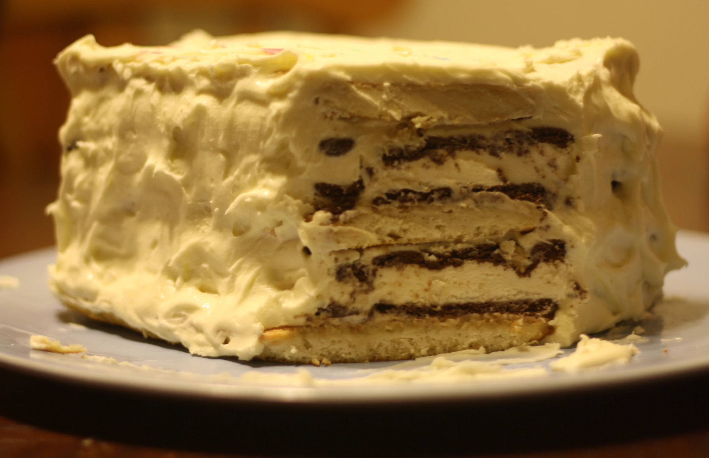 a white cake sitting on top of a blue plate