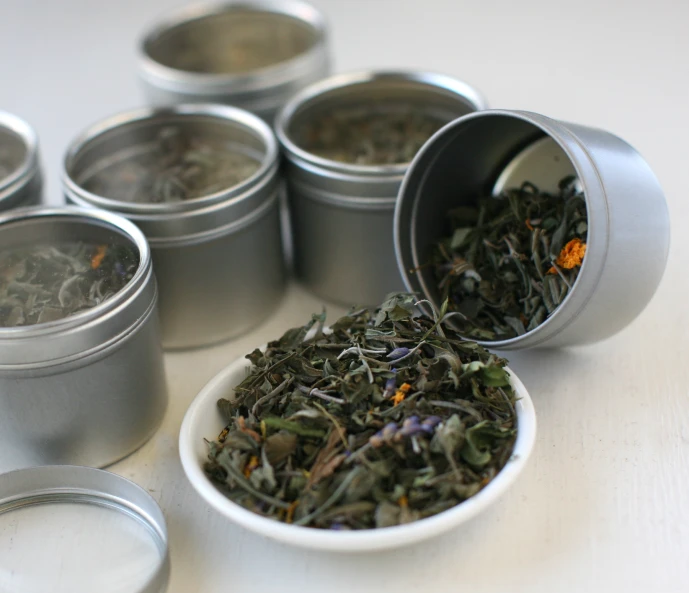 a bowl with several cups filled with tea leaves