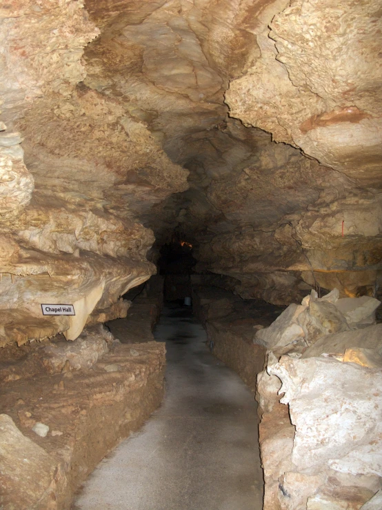 a narrow cave filled with various stone formations