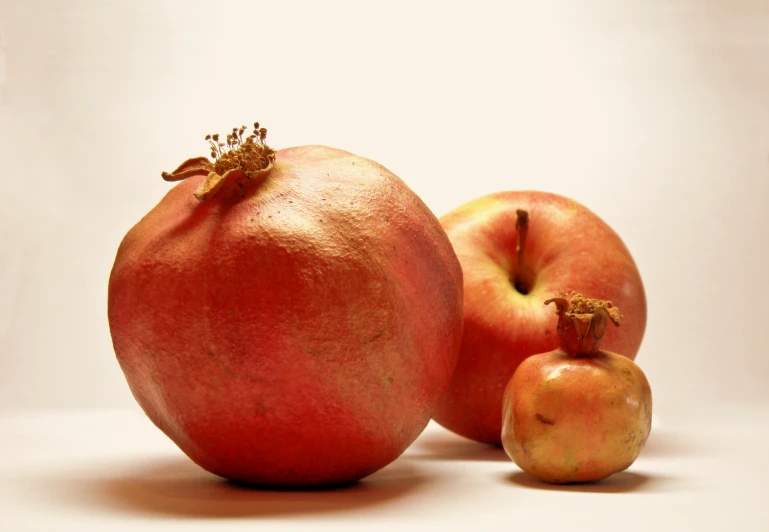 a couple of red fruit sitting on top of each other