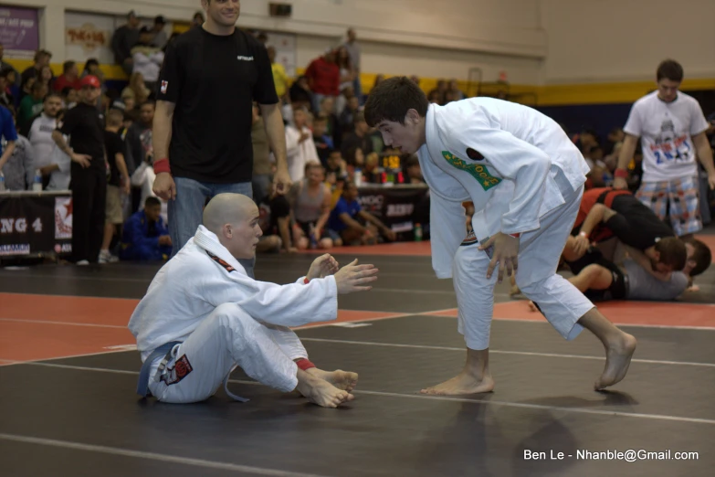 two men doing karate with a crowd watching