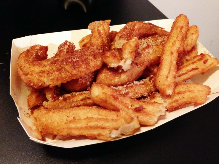 some fried food on a plate with fries and dip