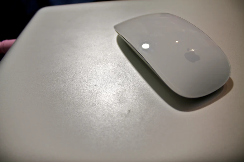 a computer mouse with a silver on sits on top