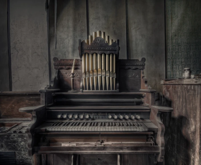 a broken pipe sitting on top of an organ