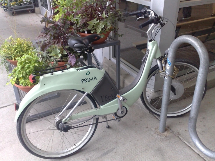 an open bicycle with some potted plants by it