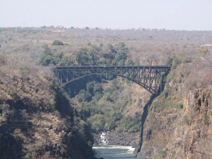 a train crossing an old bridge on a river