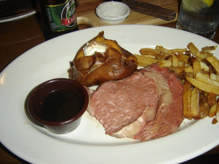 a white plate topped with lots of meat and fries