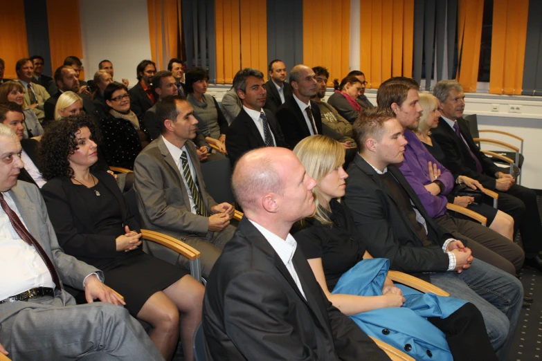 a group of people at a conference in front of an audience