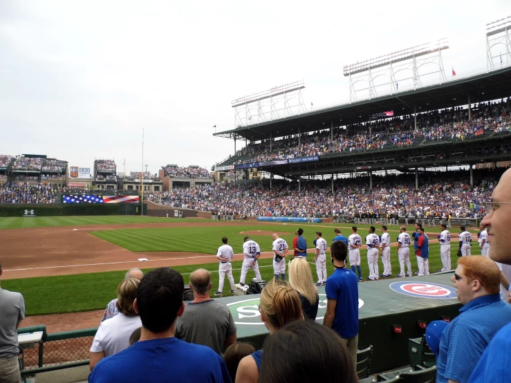 there is a baseball team standing in a stadium