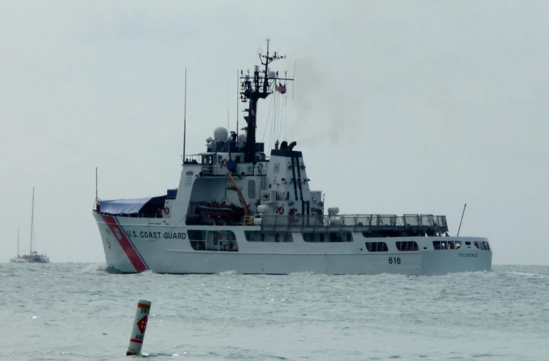 two boats, one large, the other small, in choppy water