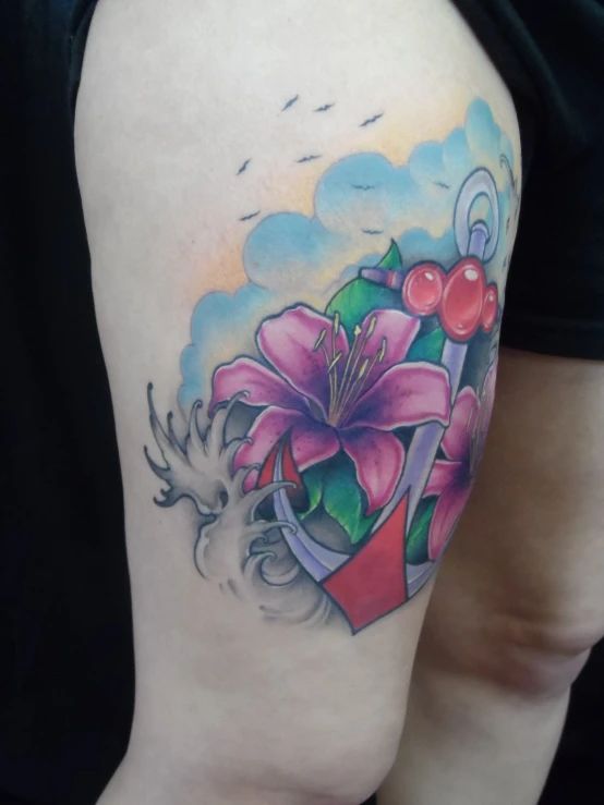 a colorful picture of a flower tattoo on the lower leg