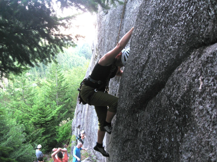 a person climbing on top of a rock