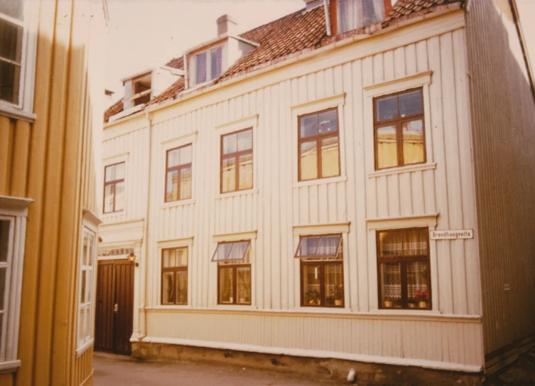 a large white building sitting next to some tall buildings