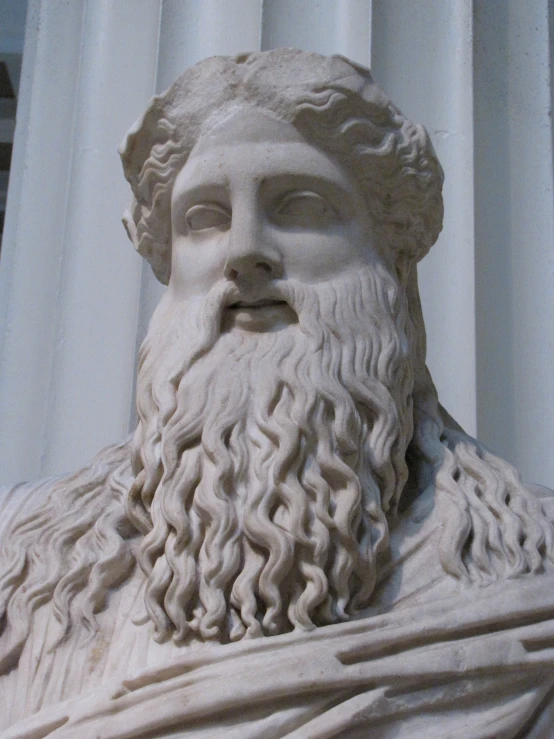 a stone statue that has long white beard and bearding