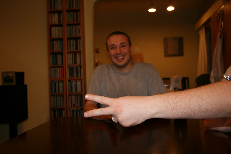 a hand extended up in the air over a table