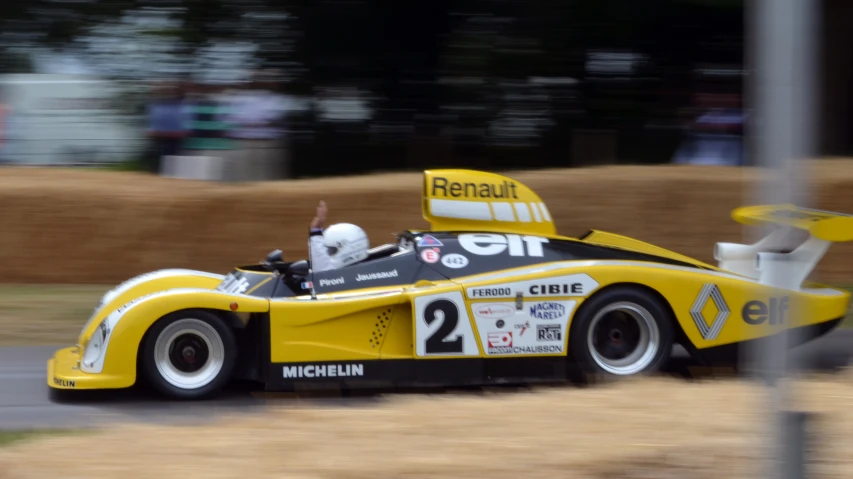 a race car racing on a track with spectators